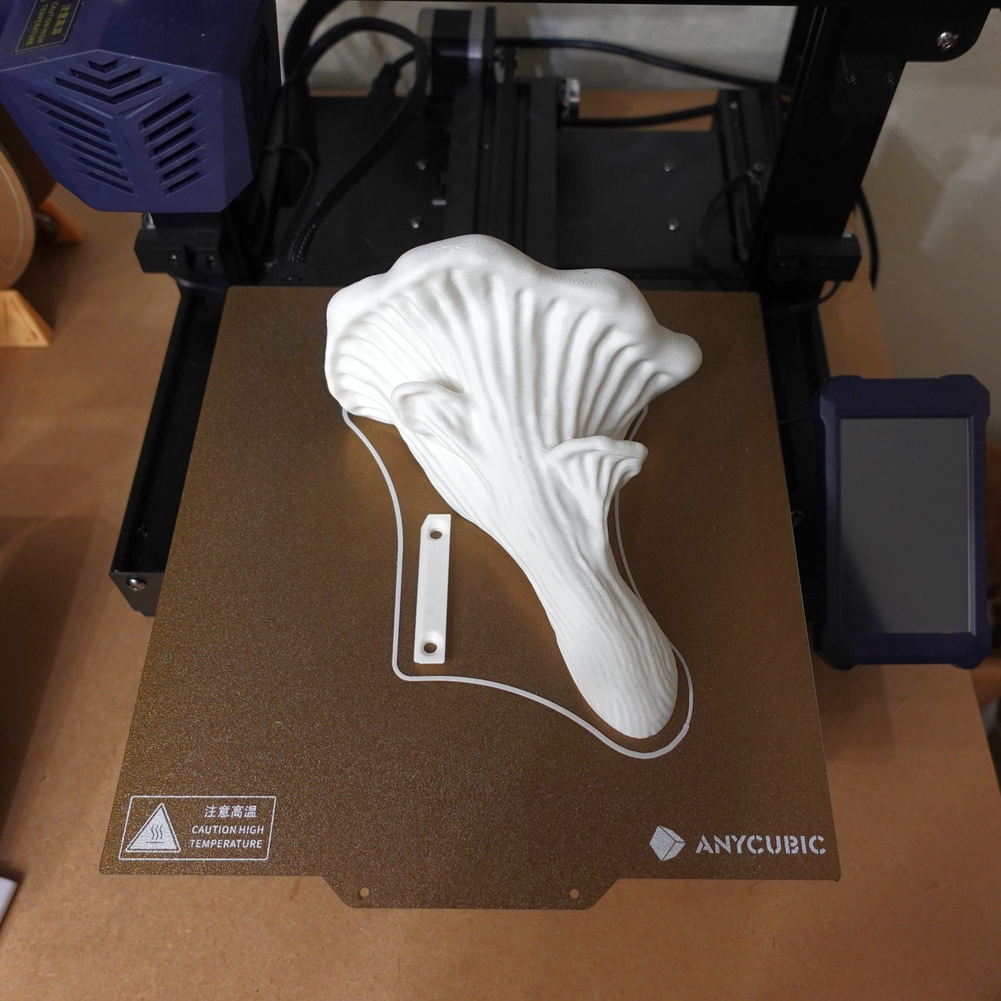 3D printer setup with a white Oyster Mushroom Shelf printing on the bed, highlighting the design process.