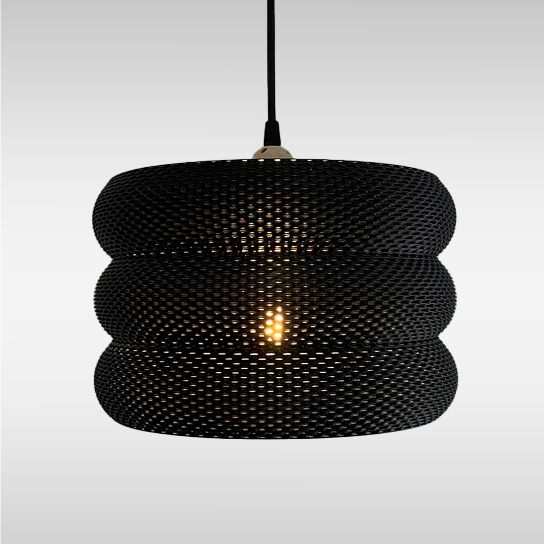 Mara Lampshade featuring a stylish curved design and intricate RippleMesh texture, beautifully illuminating a minimalist space.
