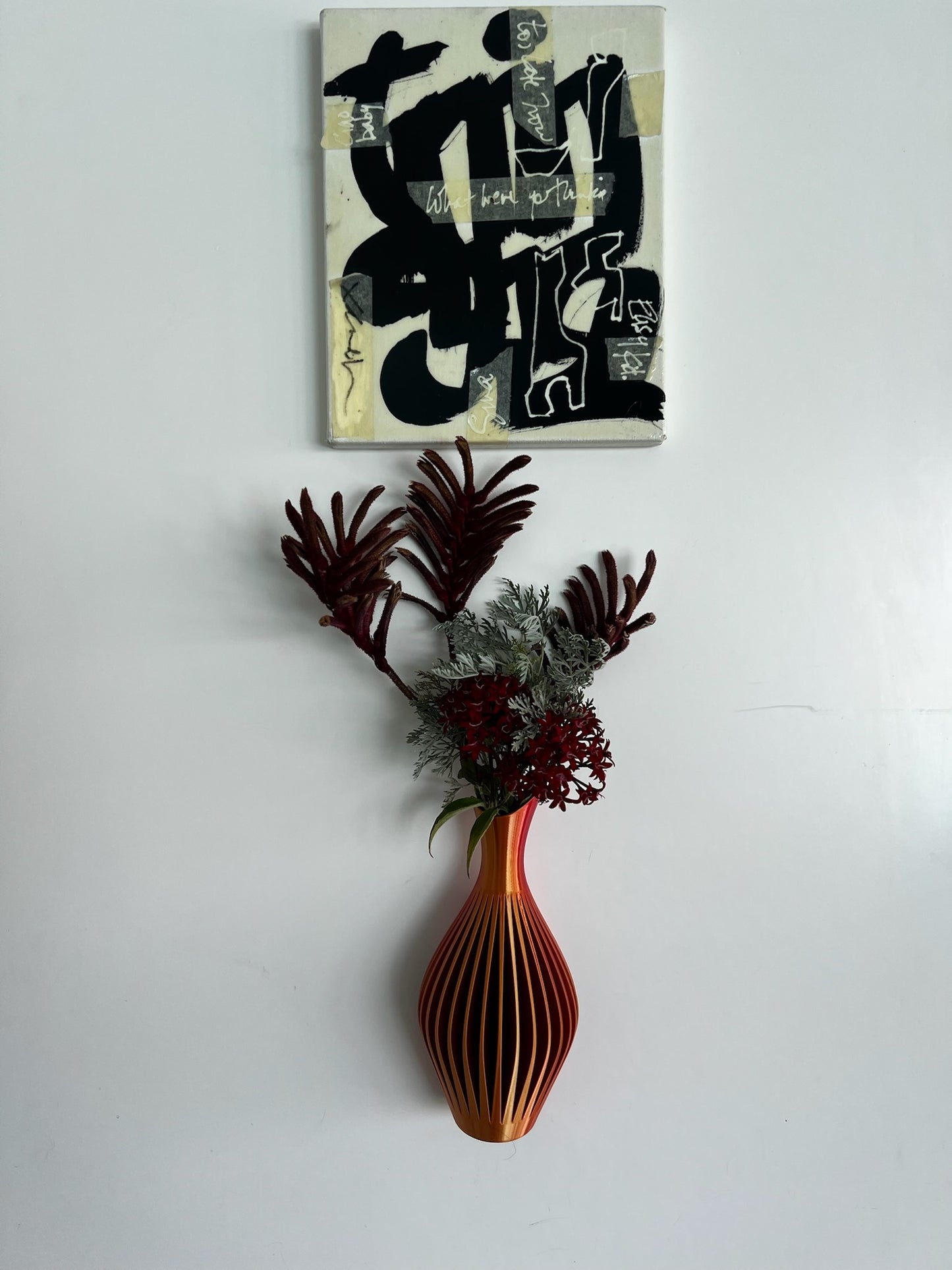 Sleek navy blue wall vase filled with vibrant flowers, adding a touch of elegance to home decor.