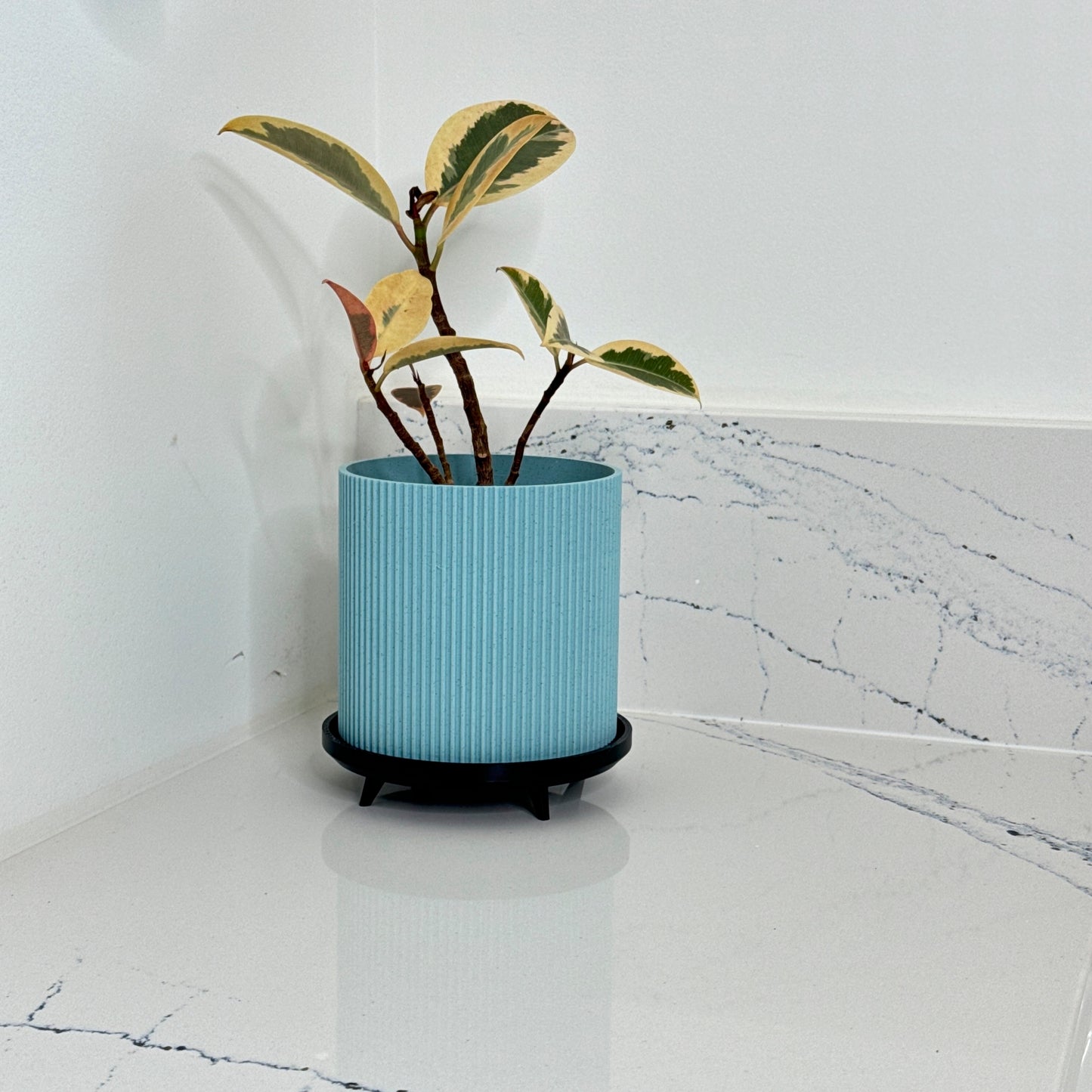 Textured planter set – Beautifully designed ribbed plant pot with a modern black stand, available in various sophisticated marble tones to complement any decor.