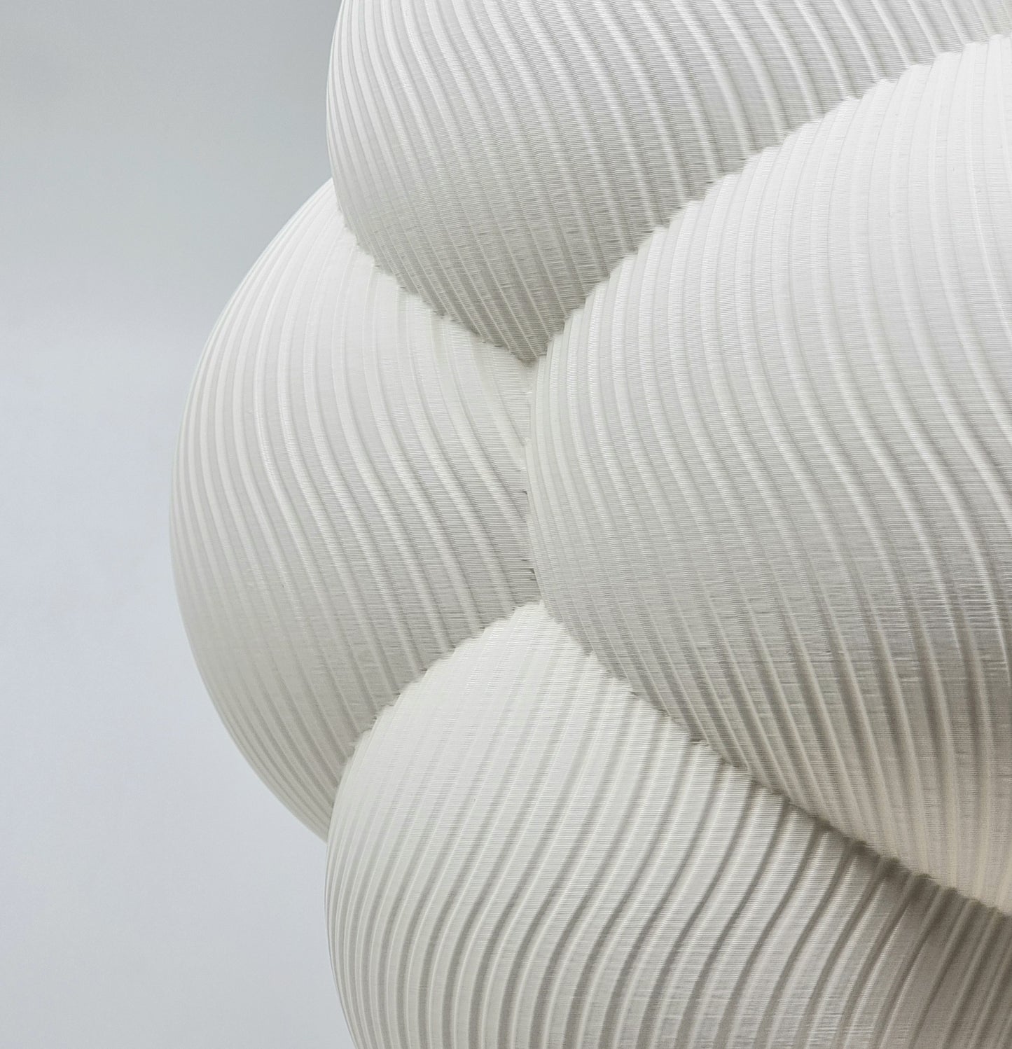 Close-up view of a Cumulus Cloud lampshade, highlighting the intricate textured design and soft white finish that enhances its modern aesthetic.