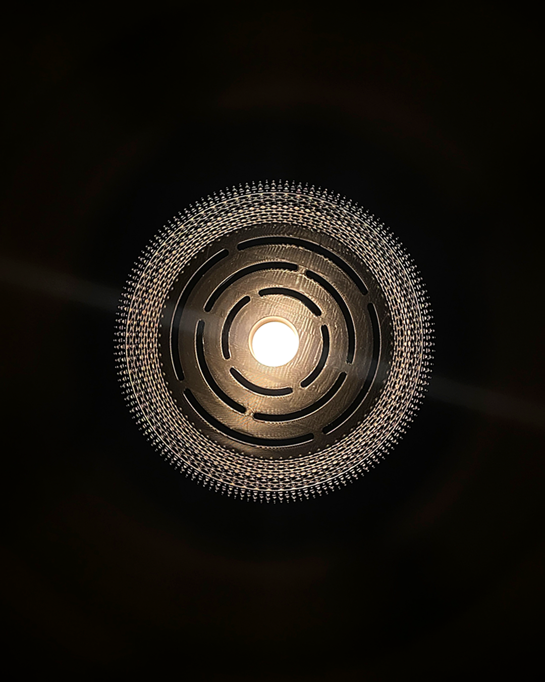 Detailed view from below of the Mara Lampshade, revealing intricate patterns while diffusing light beautifully.