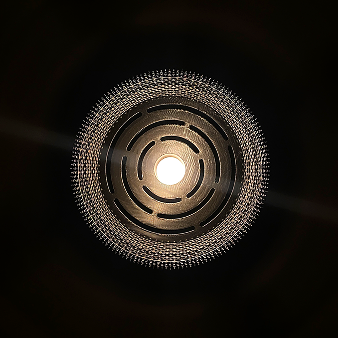 Detailed view from below of the Mara Lampshade, revealing intricate patterns while diffusing light beautifully.