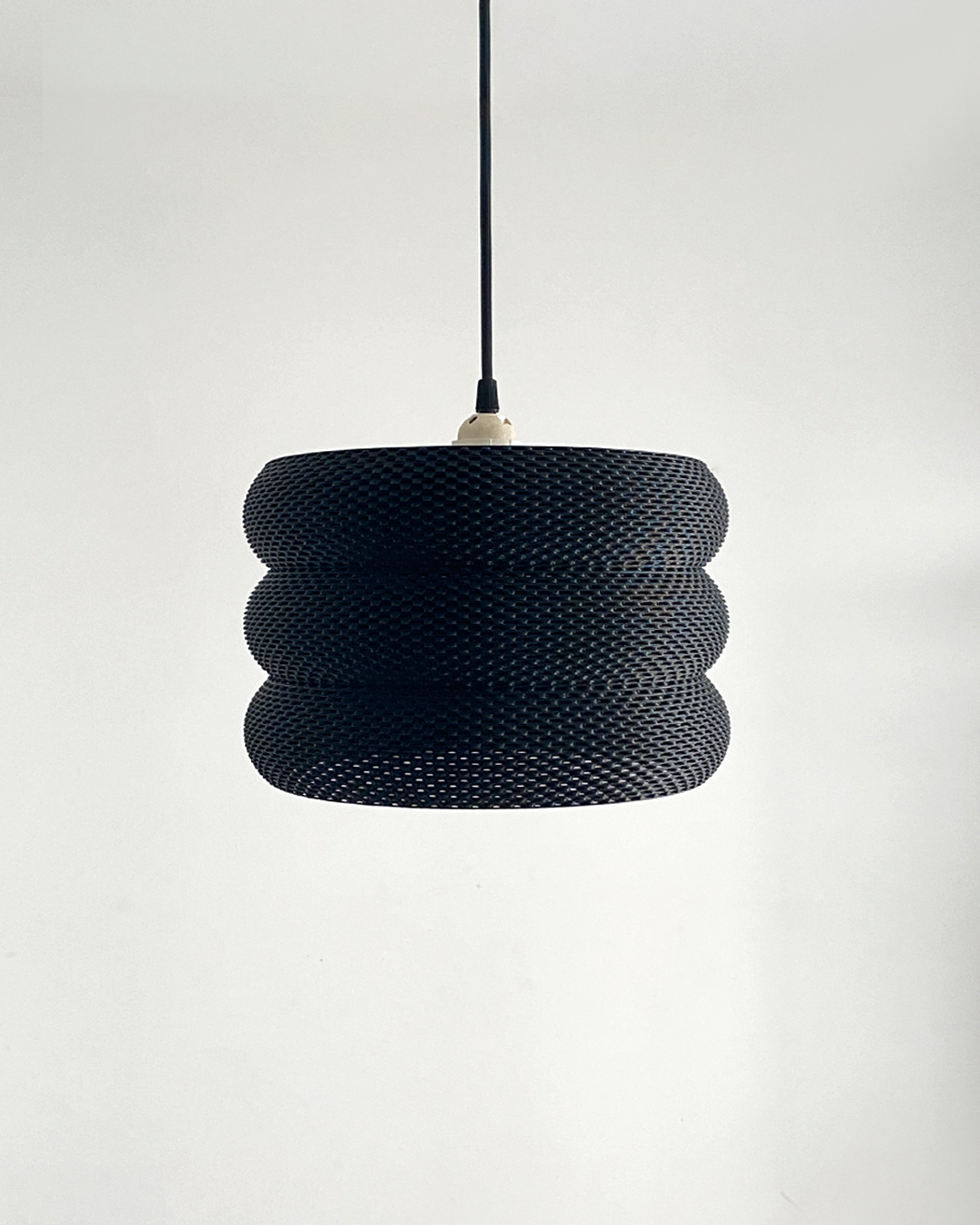 Mara Lampshade illuminating a softly lit space, enhancing the ambiance with its elegant design.