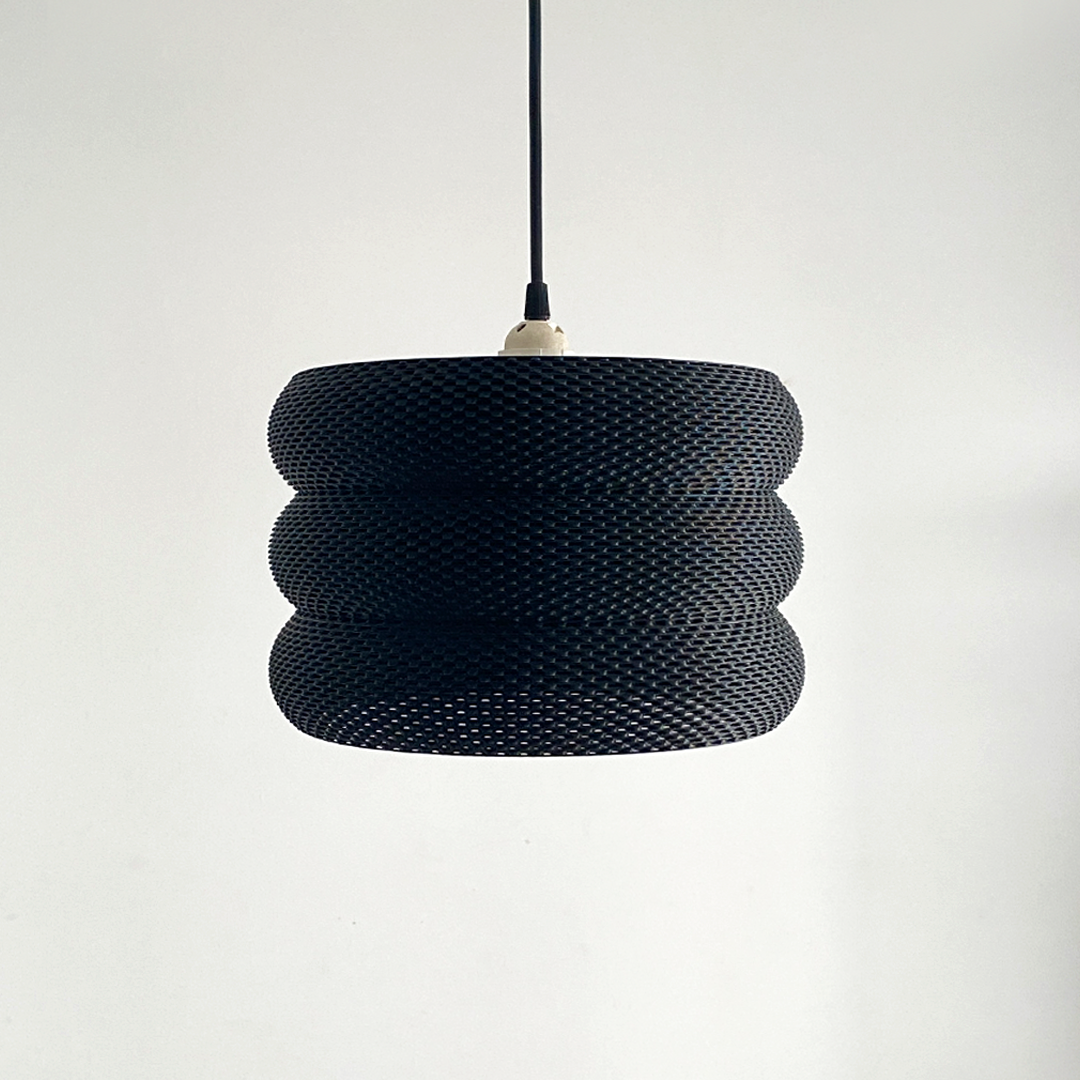 Mara Lampshade illuminating a softly lit space, enhancing the ambiance with its elegant design.