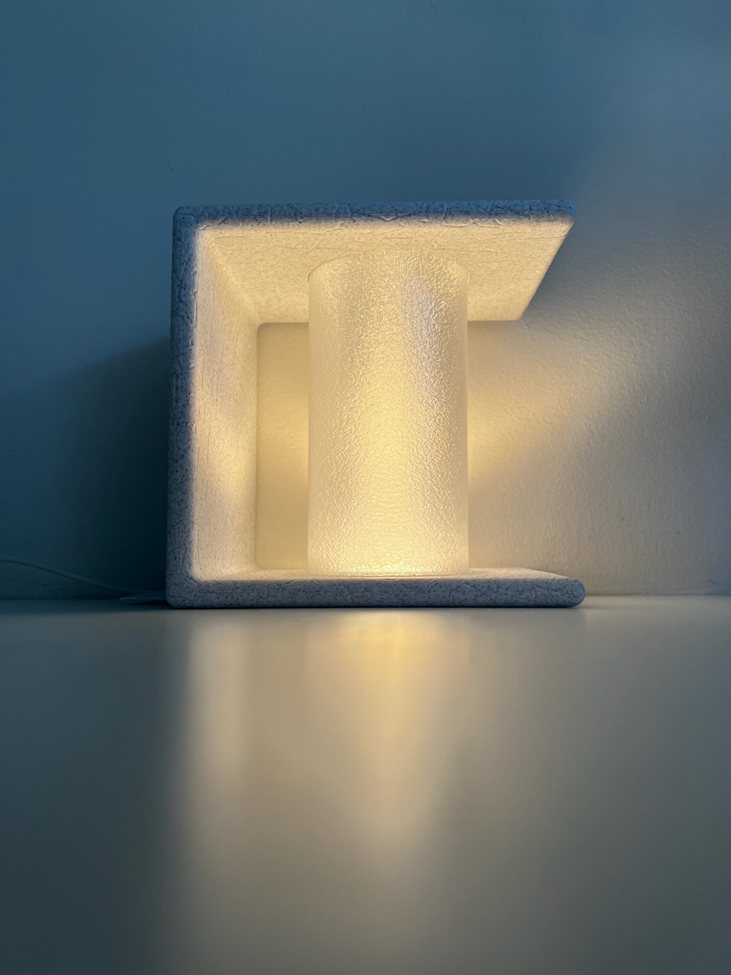 Bright, candle-like light from an Ancient Marble Bookend, designed to add charm to any reading area.