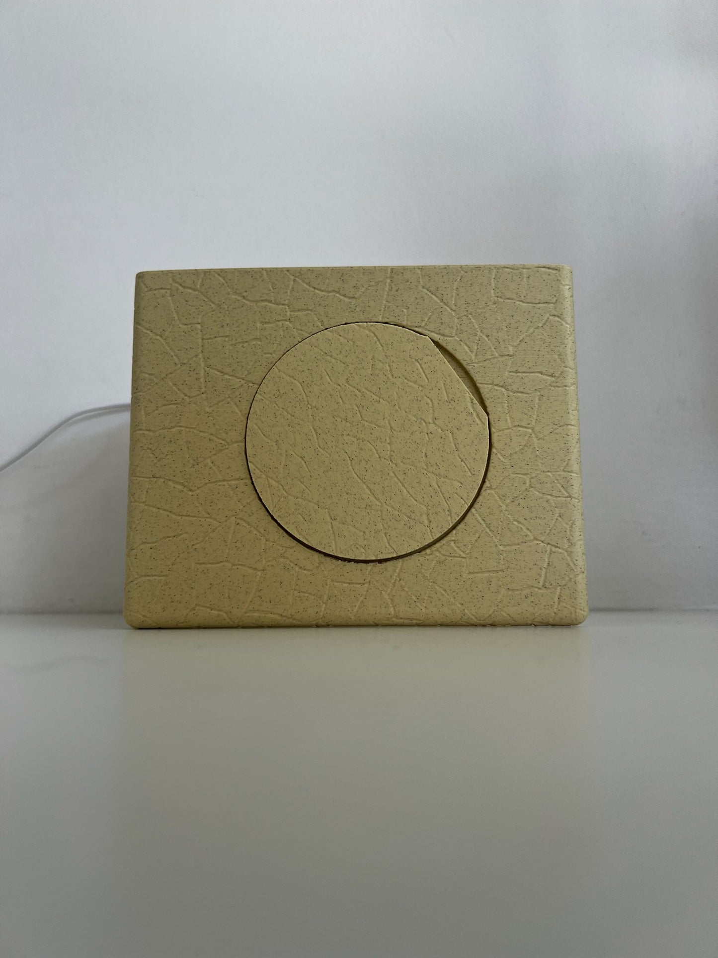 Gently glowing Ancient Marble Mood Setting Bookend in a minimalistic setup.