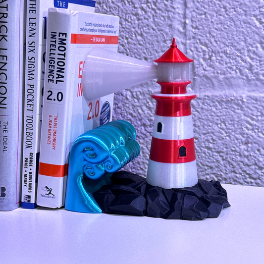 Colorful whimsical lighthouse bookend holding books, featuring a bright red and white lighthouse design with a decorative wave in blue.