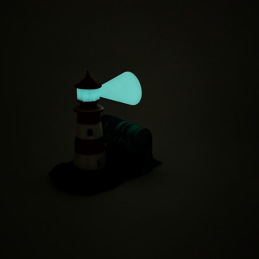 Glow in the dark feature of a lighthouse bookend, highlighting its artistic glow in a dark setting.