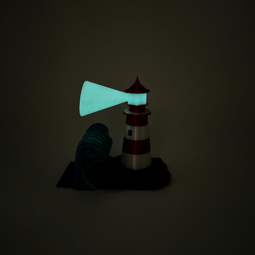 Glow in the dark lighthouse bookend illuminating in a dark room, showcasing its vibrant colors and whimsical design.