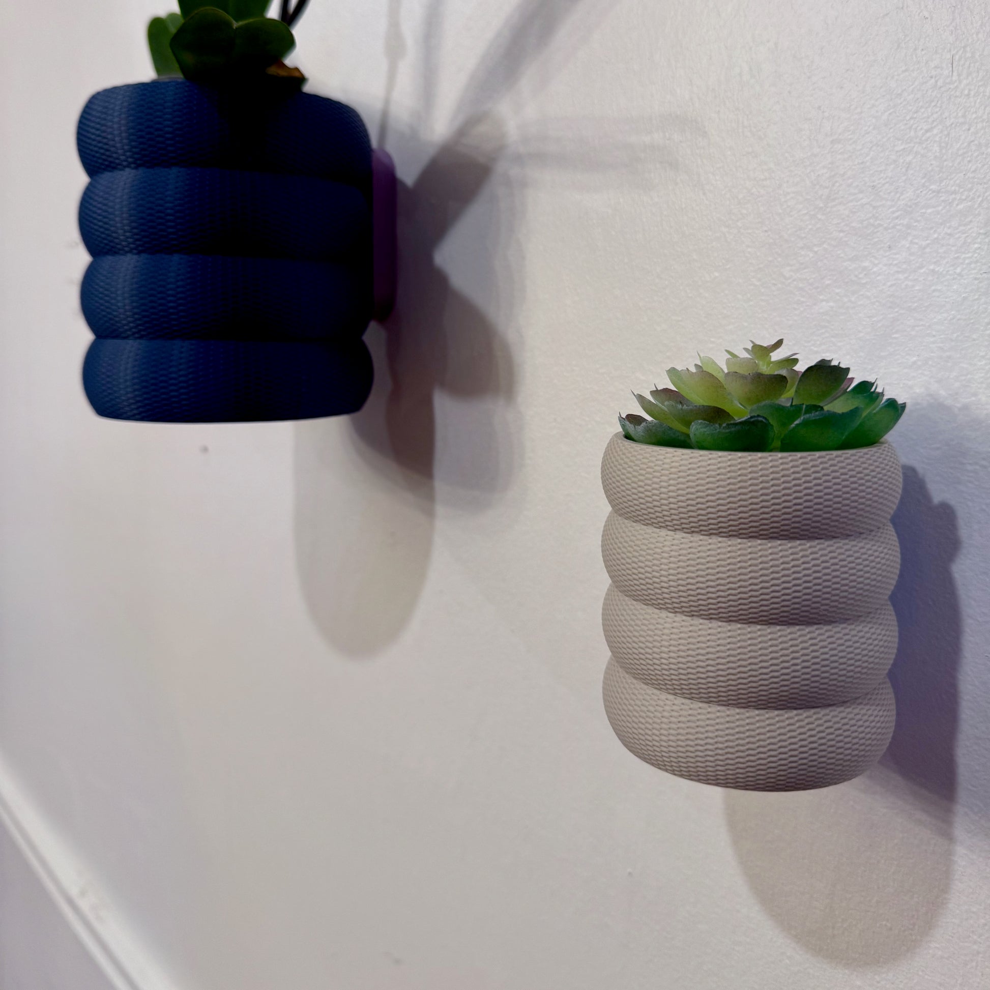 A bold and modern planter with a distinctive bubbled texture, ideal for showcasing plants in an artistic way.