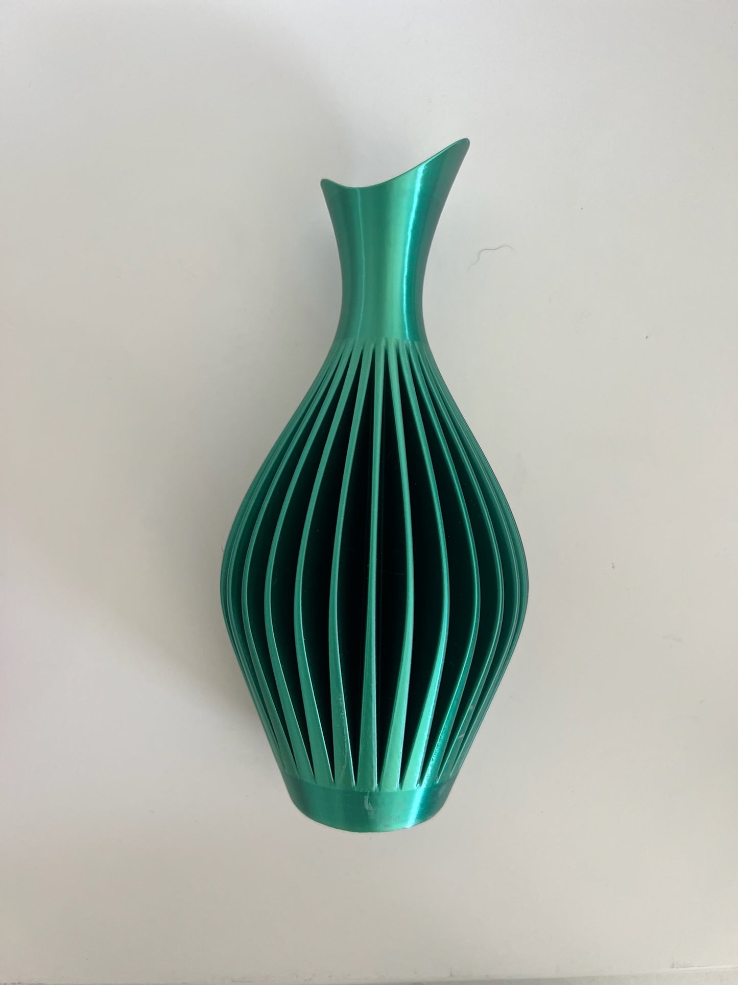 Turquoise wall vase with a chic design elegantly displayed against a white background.