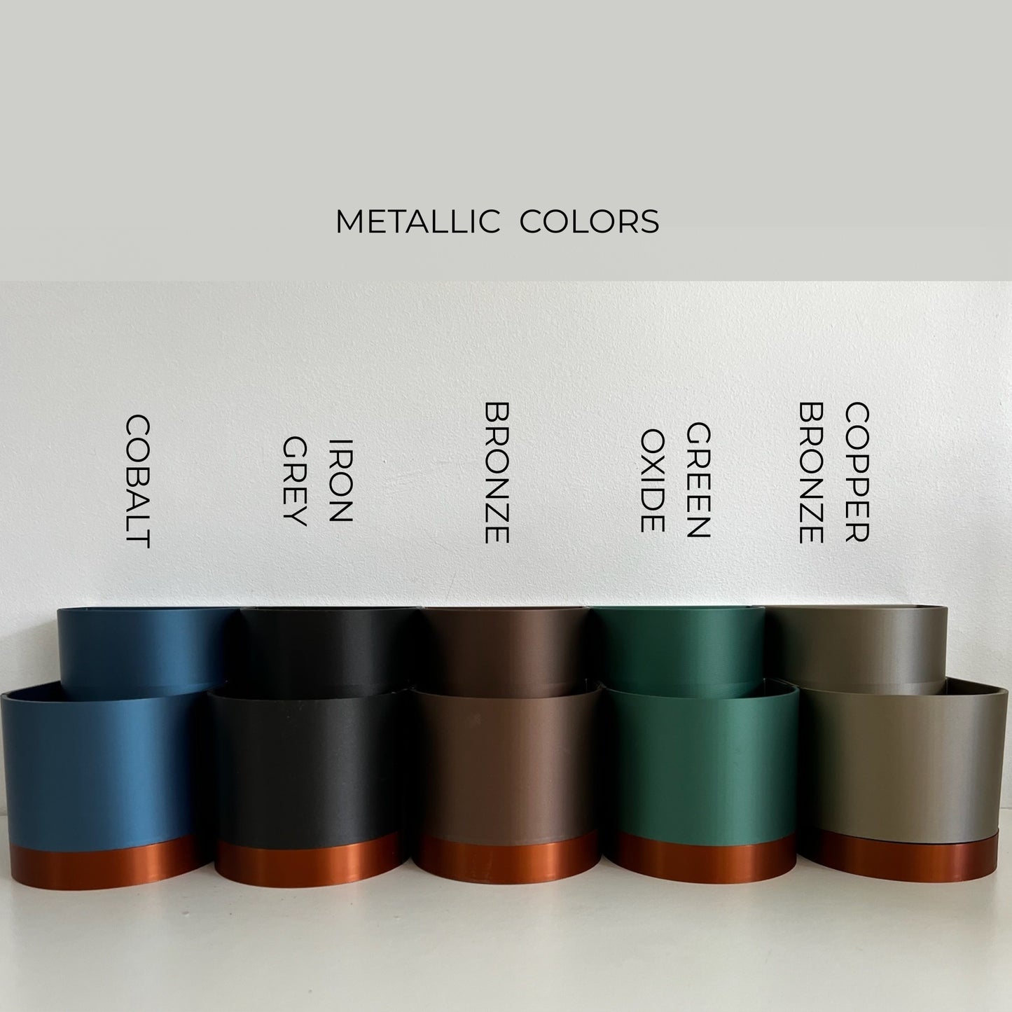 A display of various metallic planter colors, complementing the Storylight Moodlight & Bookmark Set and reinforcing its stylish, versatile use in home decor.