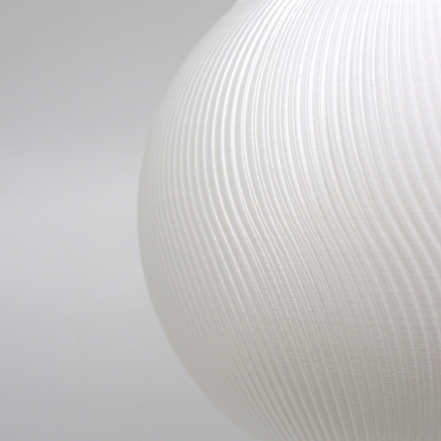 Detailed view of a textured white lampshade, highlighting its modern aesthetic and light-diffusing qualities.