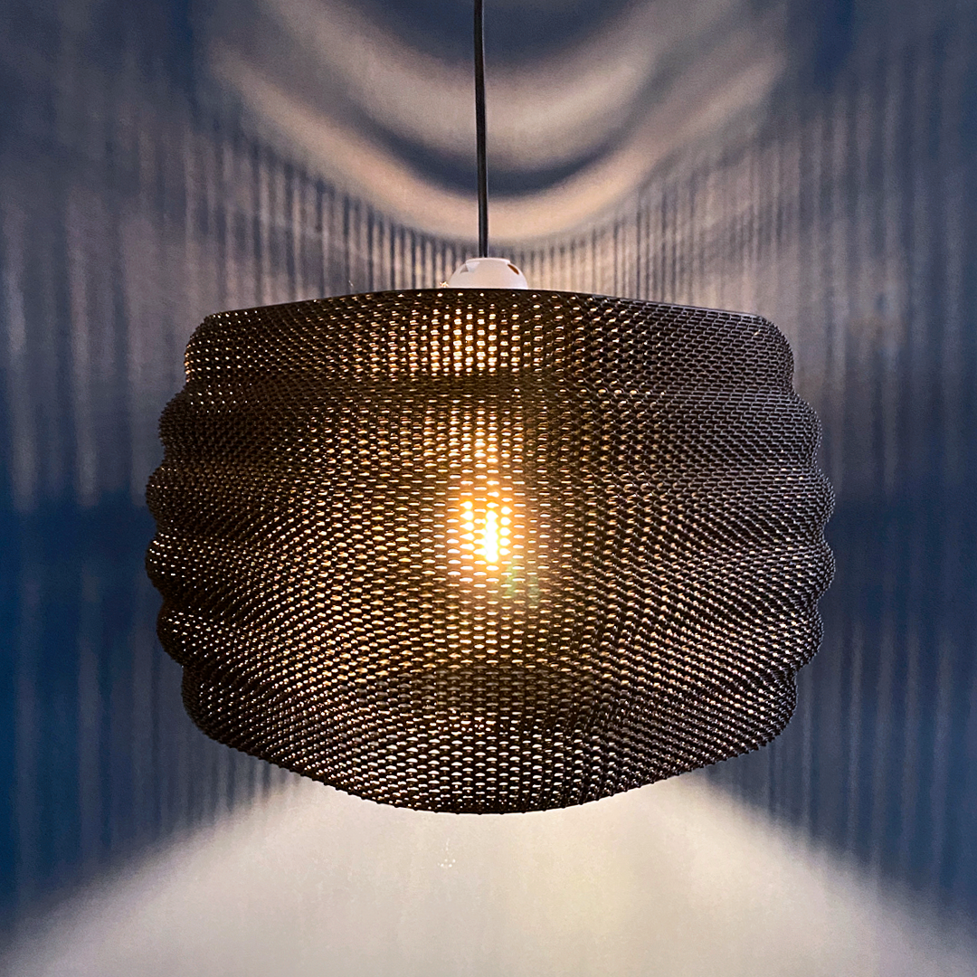 Daira Lampshade in a striking design with rich orange tones, showcasing a unique texture that enhances its visual appeal.