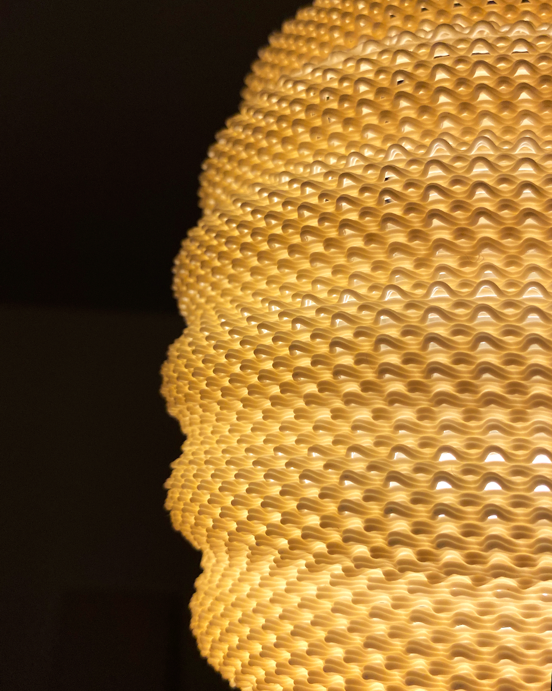 Close-up of a Daira Lampshade in orange, focusing on its unique textured design that elegantly diffuses light.