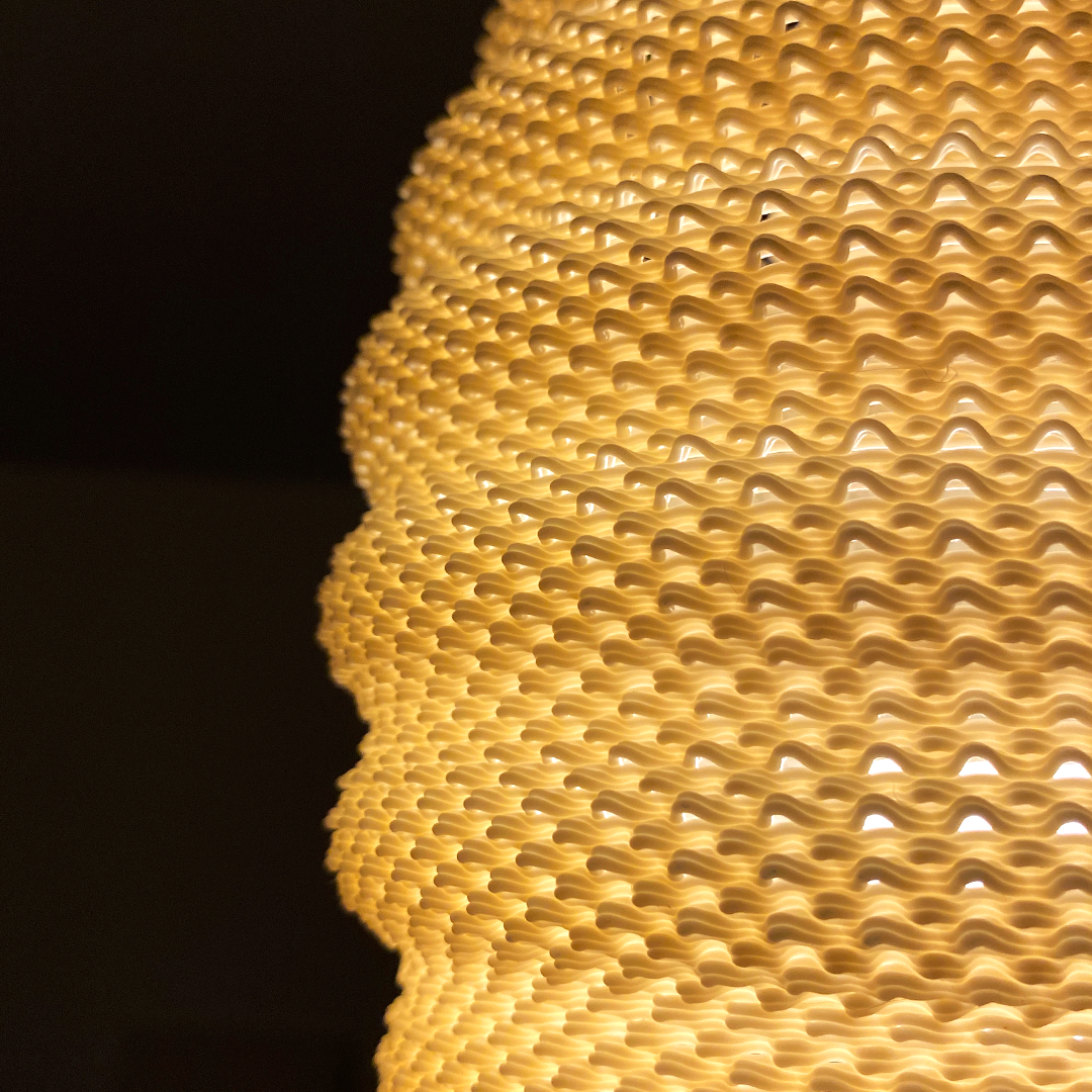 Close-up of a Daira Lampshade in orange, focusing on its unique textured design that elegantly diffuses light.