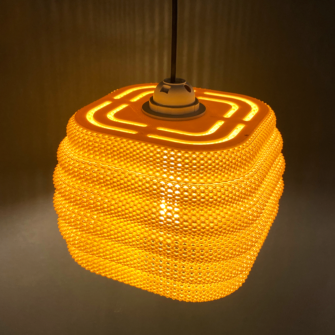 Daira Lampshade in orange with a contemporary square top, illuminating beautifully to enhance interior decor.