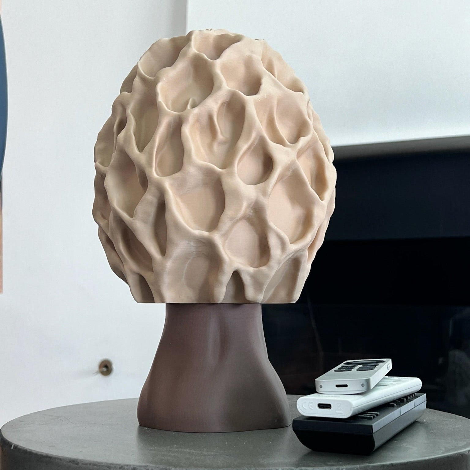 Morel-inspired lamp with warm illumination against a neutral background, showcasing its unique design.