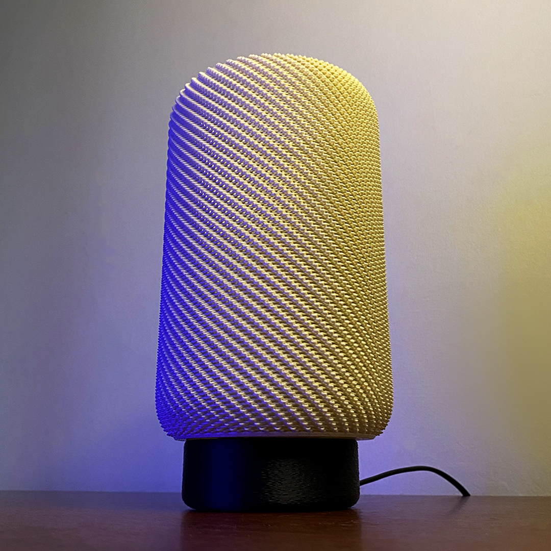 EVE Table Lamp showcasing a soft yellow light with a textured cylindrical design, creating a cozy atmosphere against a subtle gradient background.