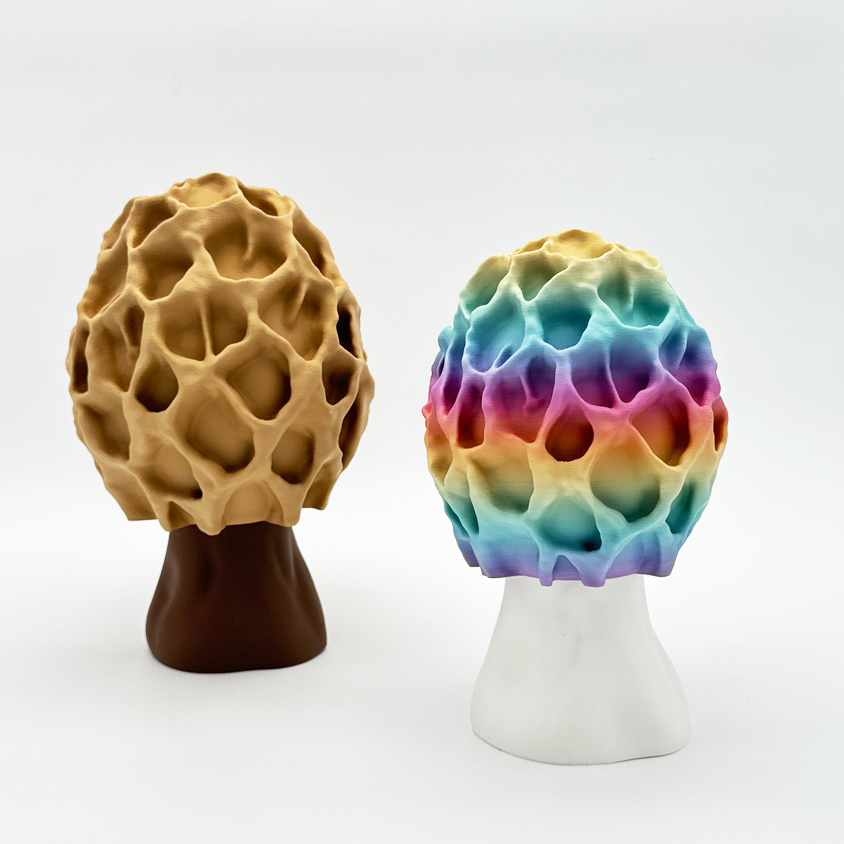 Side view of two Morel-inspired lamps, one vibrant and colorful, and the other in a natural beige hue.