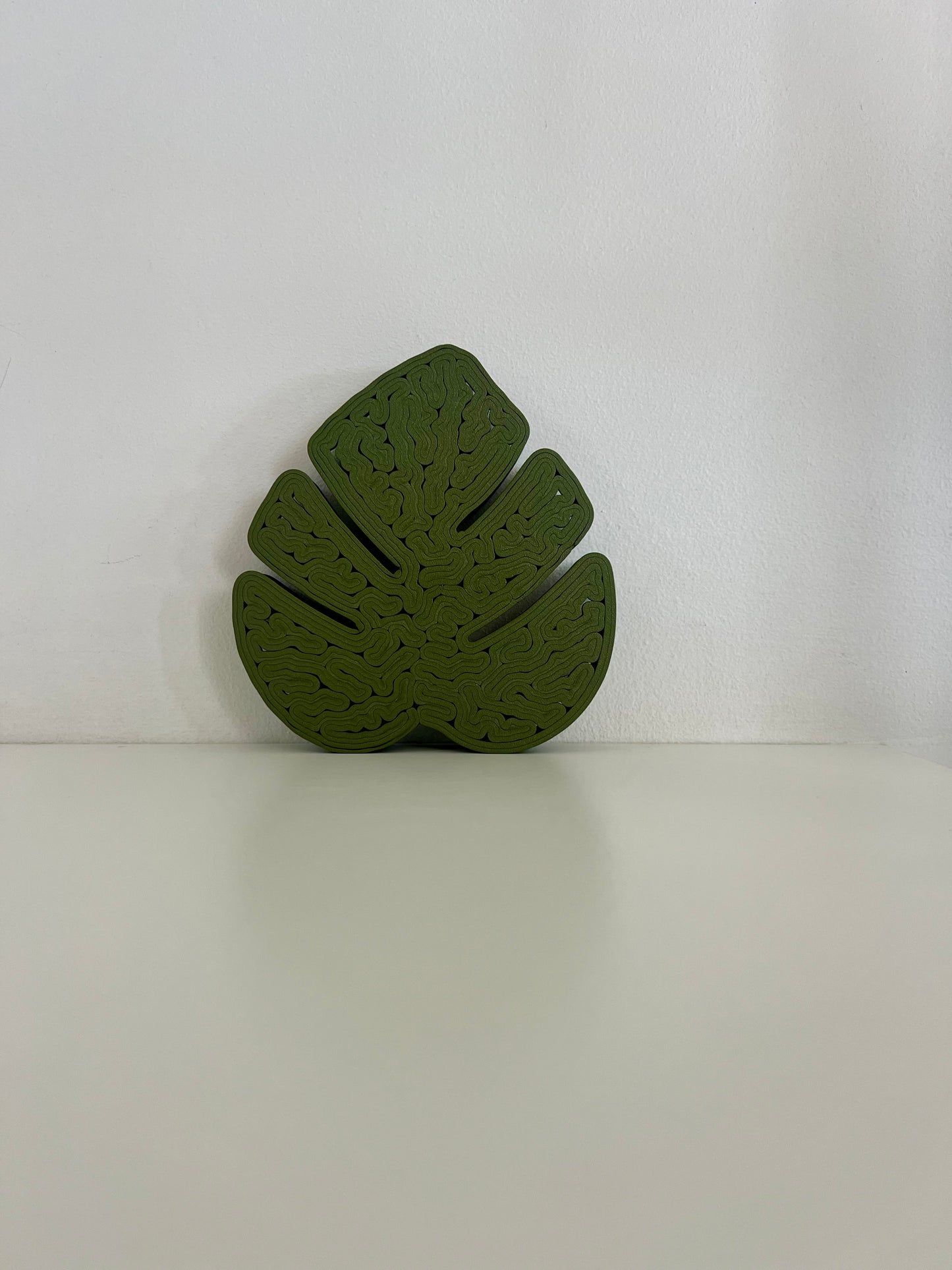 Top view of a green Monstera leaf tray, emphasizing its unique shape and elegant design.