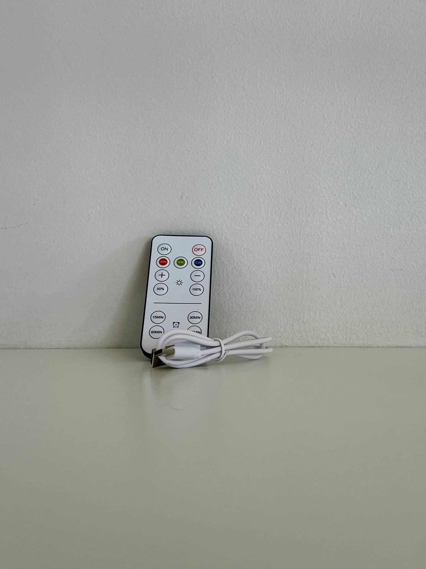 Remote control for the lighted bookend, featuring various settings for easy adjustments.