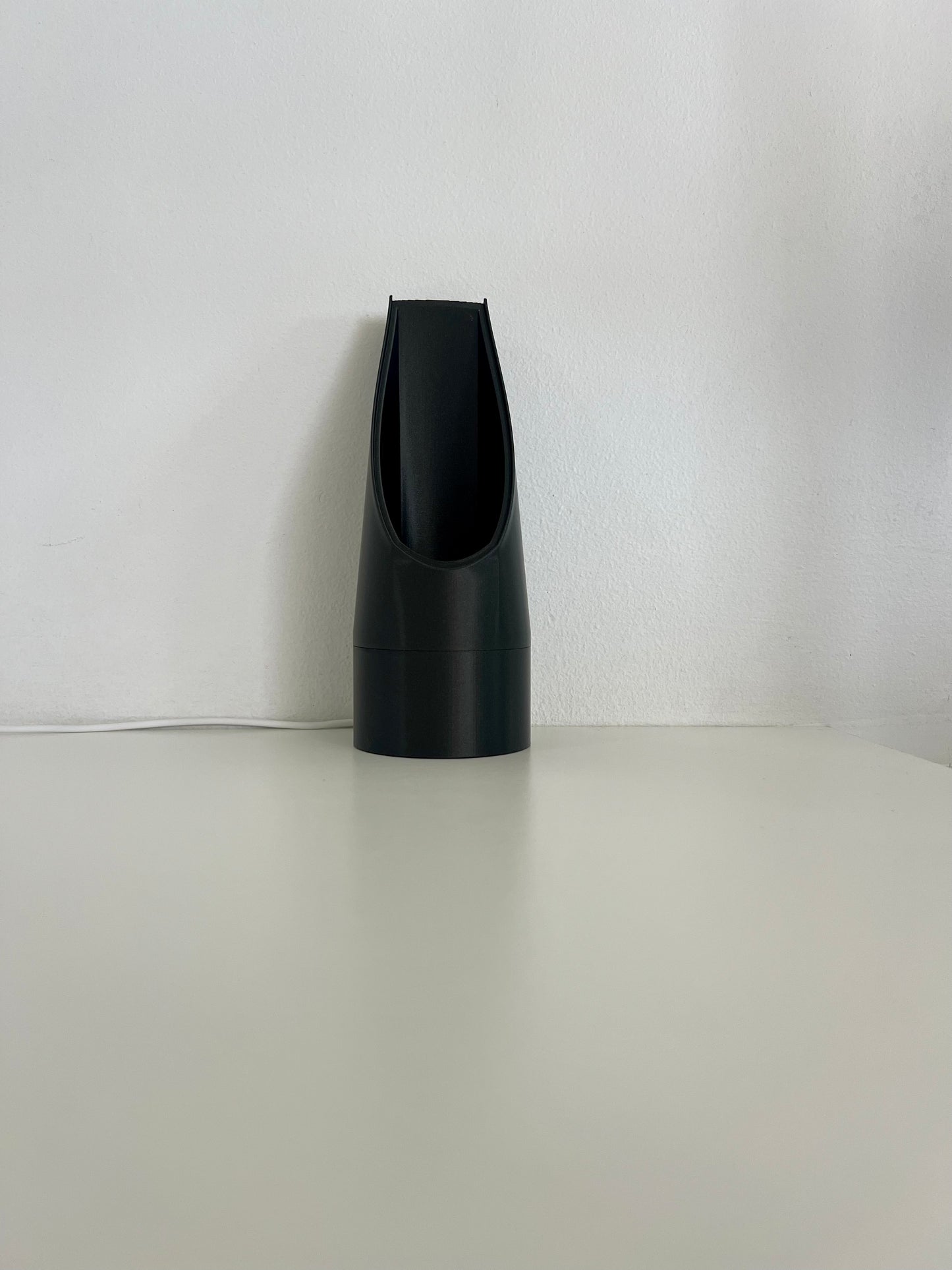 Minimalistic black mood light design, showcasing its elegant shape and function for stylish lighting purposes.