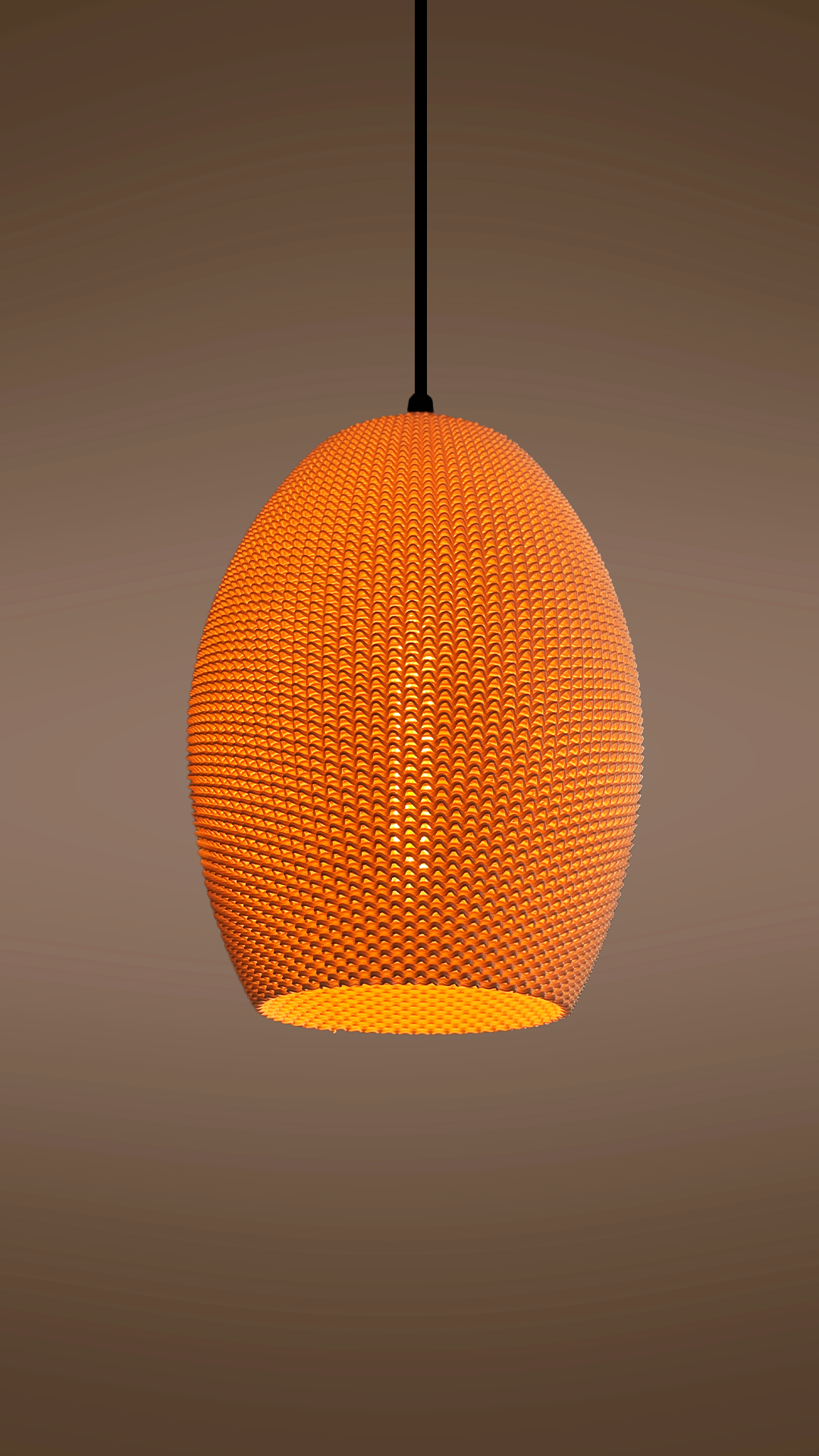 Ovo Lampshade with a spherical structure, glowing in orange against a brown backdrop, perfect for stylish home lighting.