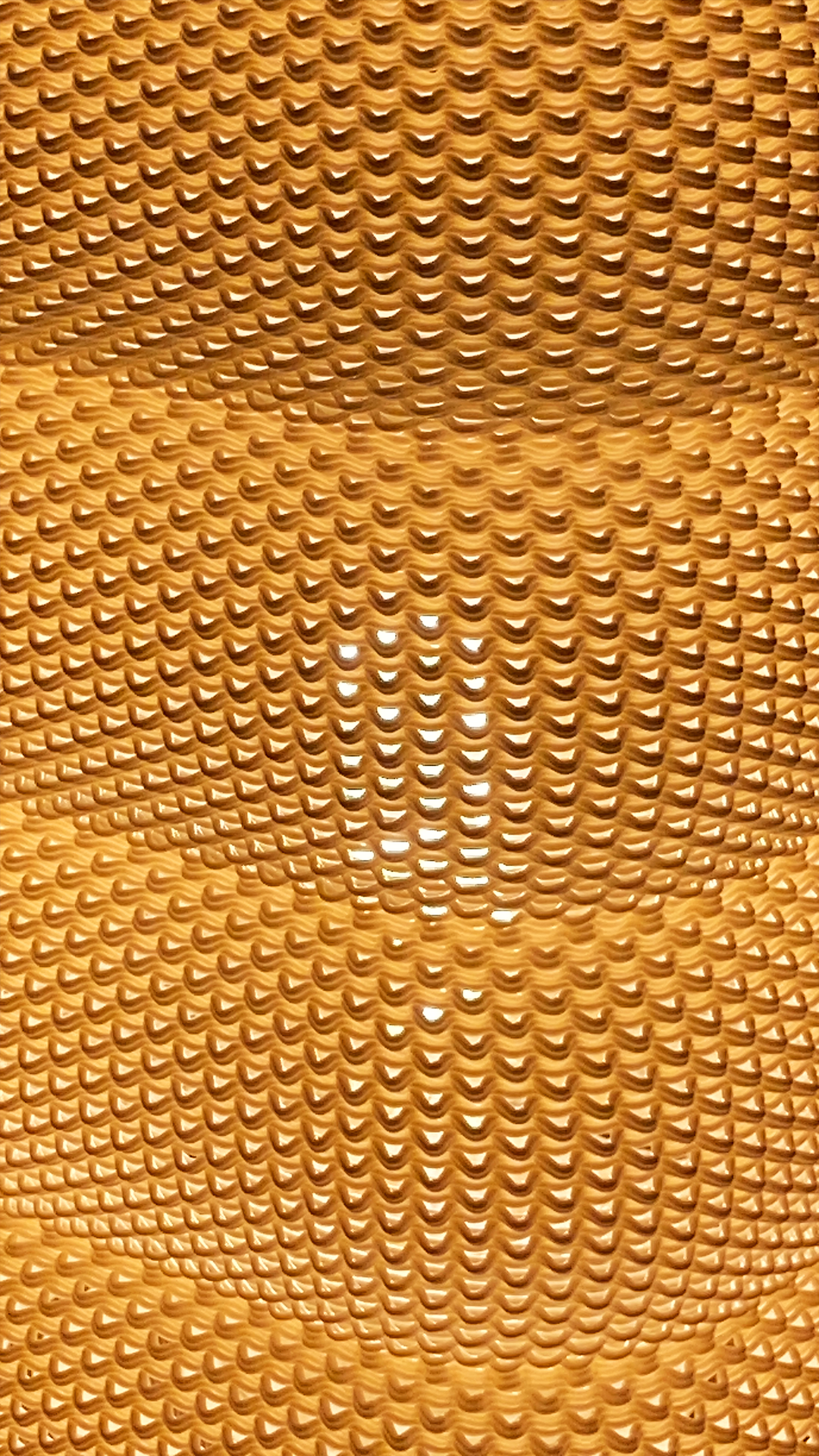 Close-up of the textured design on the SARA Table Lamp, capturing the intricate patterns and warm light diffused through the layers.