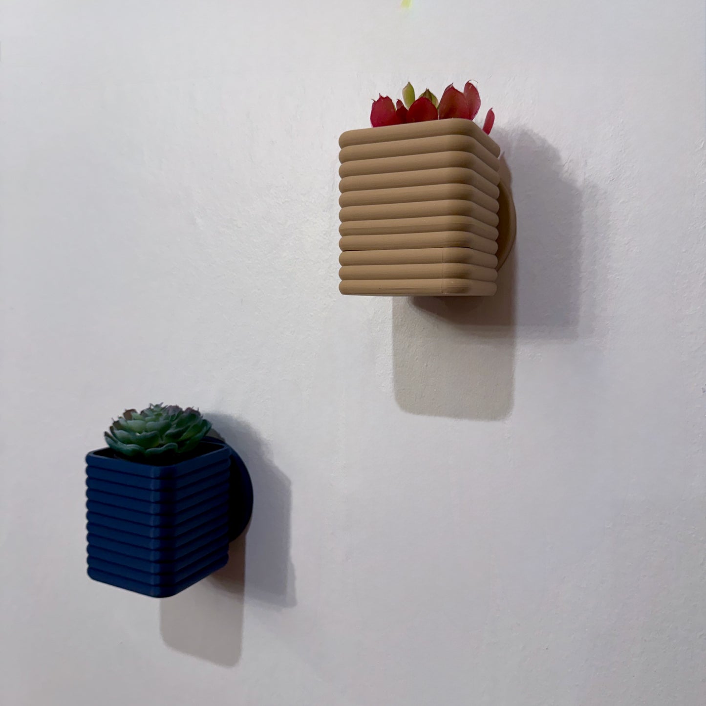 Compact & Stylish Wall Planter – A square-shaped planter with a contemporary layered design, ideal for displaying succulents or small plants.