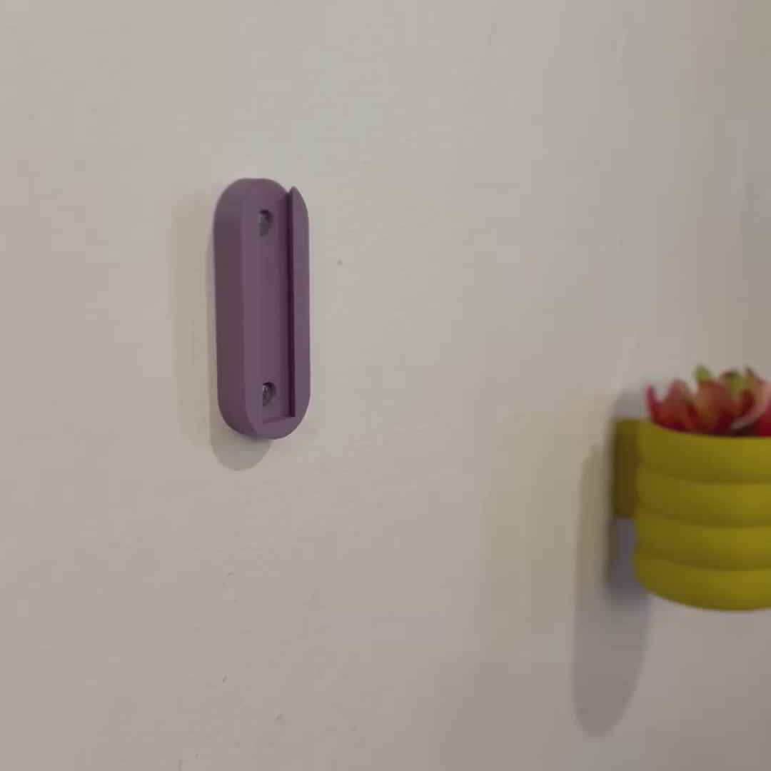 A beautifully textured wall-mounted planter with a unique bubble weave design, available in multiple colors to enhance any space.