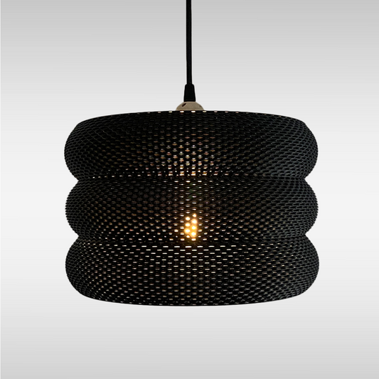 Mara Lampshade featuring a stylish curved design and intricate RippleMesh texture, beautifully illuminating a minimalist space.