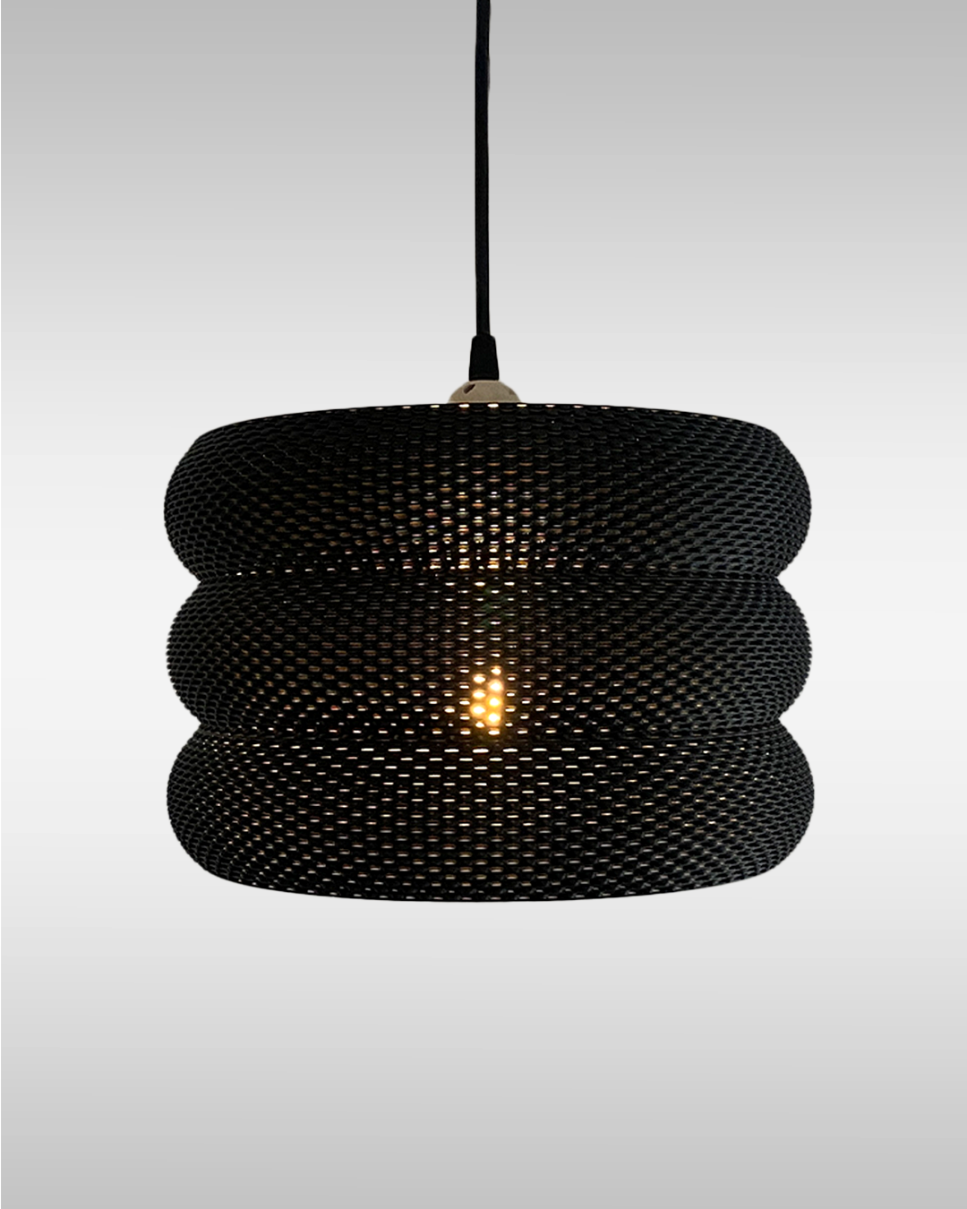 Mara Lampshade featuring a stylish curved design and intricate RippleMesh texture, beautifully illuminating a minimalist space.
