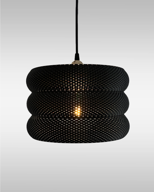 Mara Lampshade featuring a stylish curved design and intricate RippleMesh texture, beautifully illuminating a minimalist space.