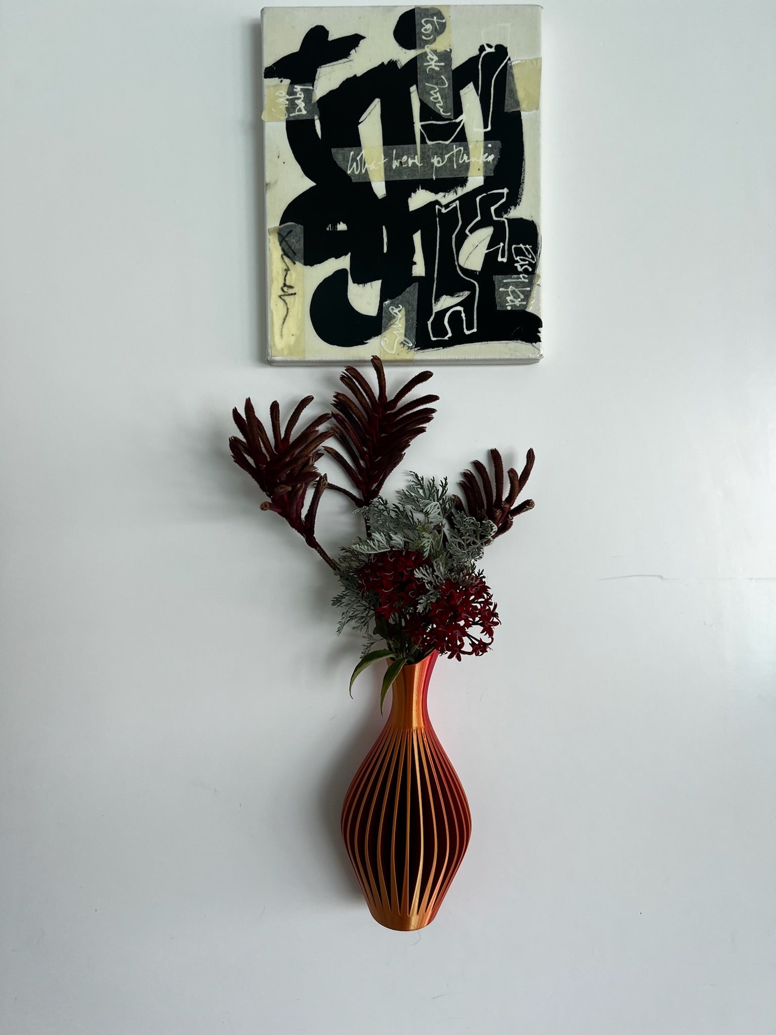 Sleek navy blue wall vase filled with vibrant flowers, adding a touch of elegance to home decor.