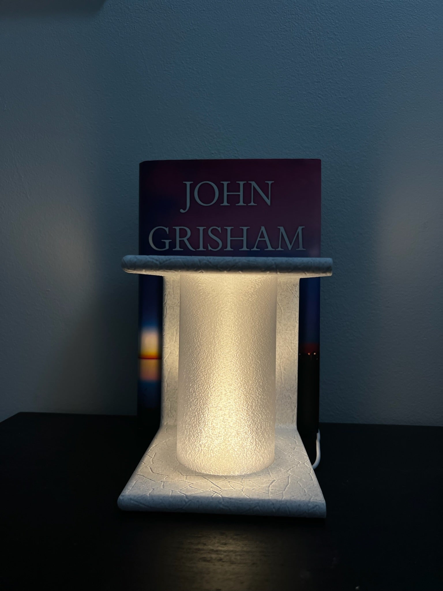 Lighted Ancient Marble Bookend showcasing its decorative function with a book in the background.