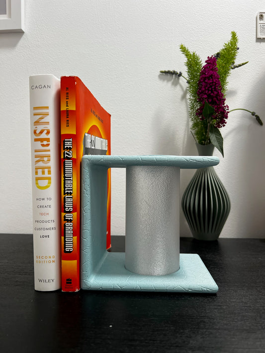 Ancient Marble Mood Setting Bookend holding books with a soft glow lighting up the space.