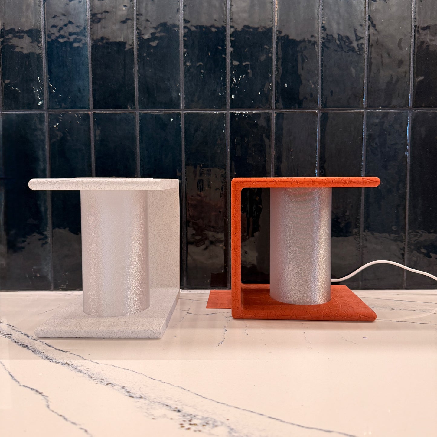 Complementary view of red and white Ancient Marble Lighted Bookends on a modern surface, enhancing the decor while supporting books.