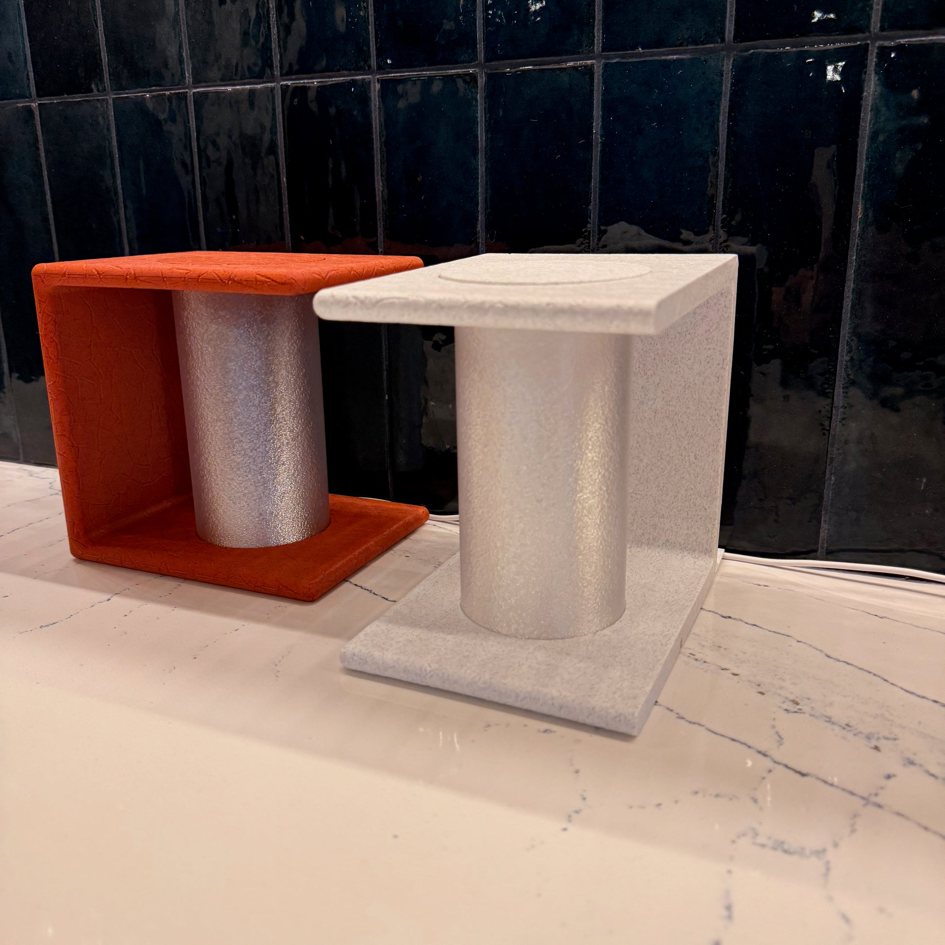 A pair of beautifully designed Ancient Marble Lighted Bookends, one red and one white, offering both functionality and aesthetic appeal.