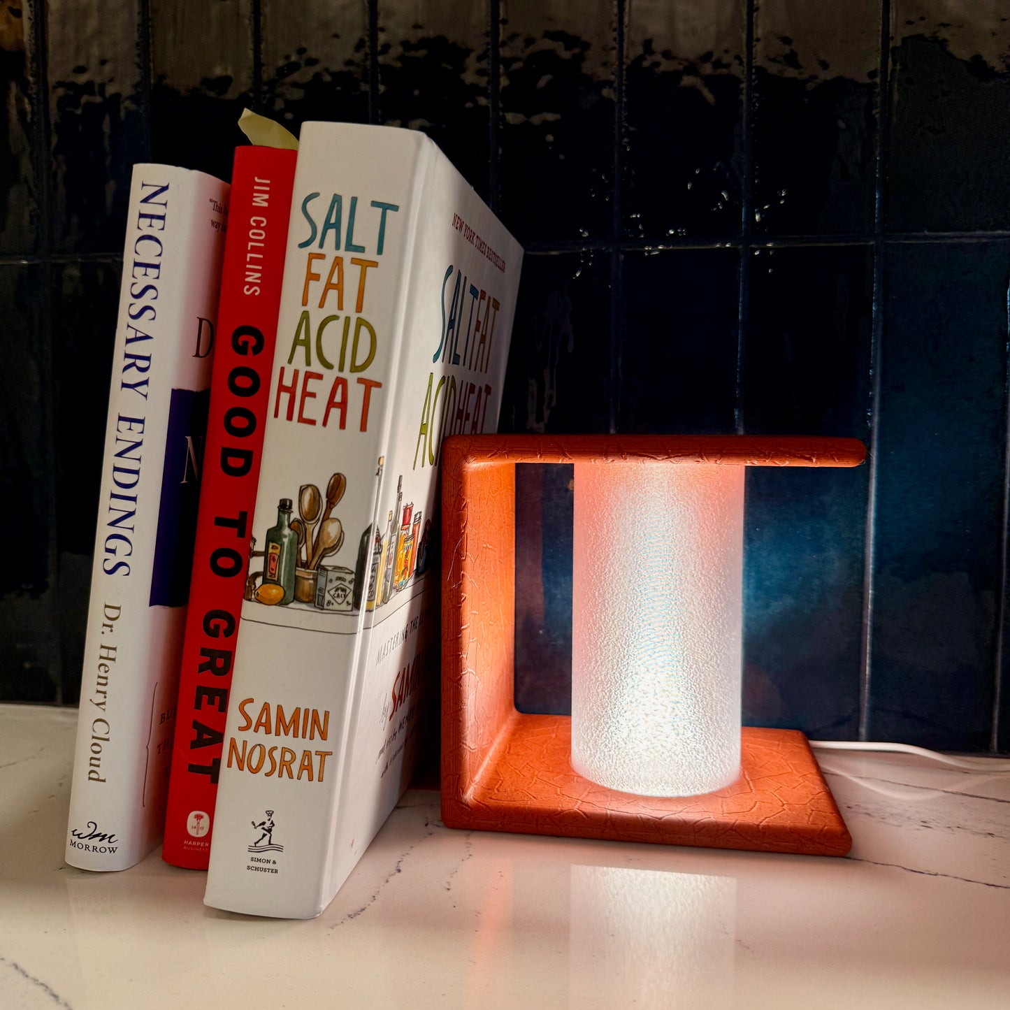 Elegant Ancient Marble Lighted Bookend with Gentle Diffuse Light illuminating books on a stylish shelf, perfect for enhancing your reading space.