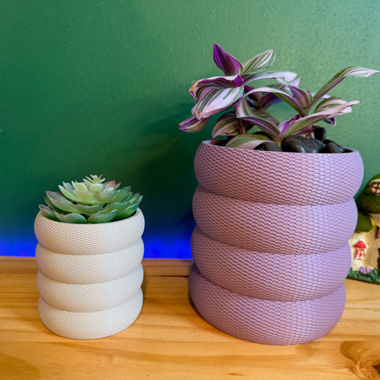 A stylish bubble weave wall planter in a variety of colors, designed to elevate your plants with a modern, textured aesthetic. The planters feature a rounded, woven pattern that adds depth and visual interest, making them a perfect addition to any indoor space.