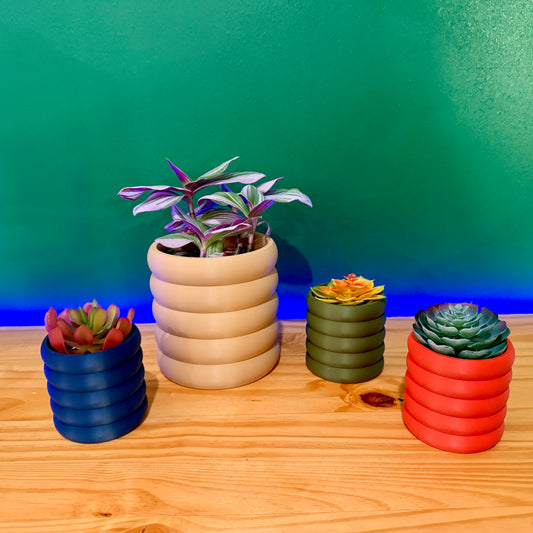 Contemporary wall planter with a smooth, sculptural look, an elegant choice for plant lovers seeking modern décor.