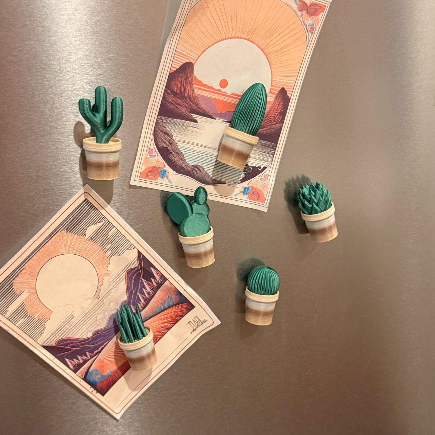 Mini Cactus Plant Pot Collection - Set of 6 Fridge Magnets displayed on a fridge, showcasing cactus and succulent magnets holding artwork, ideal for decor with cactus fridge magnets.