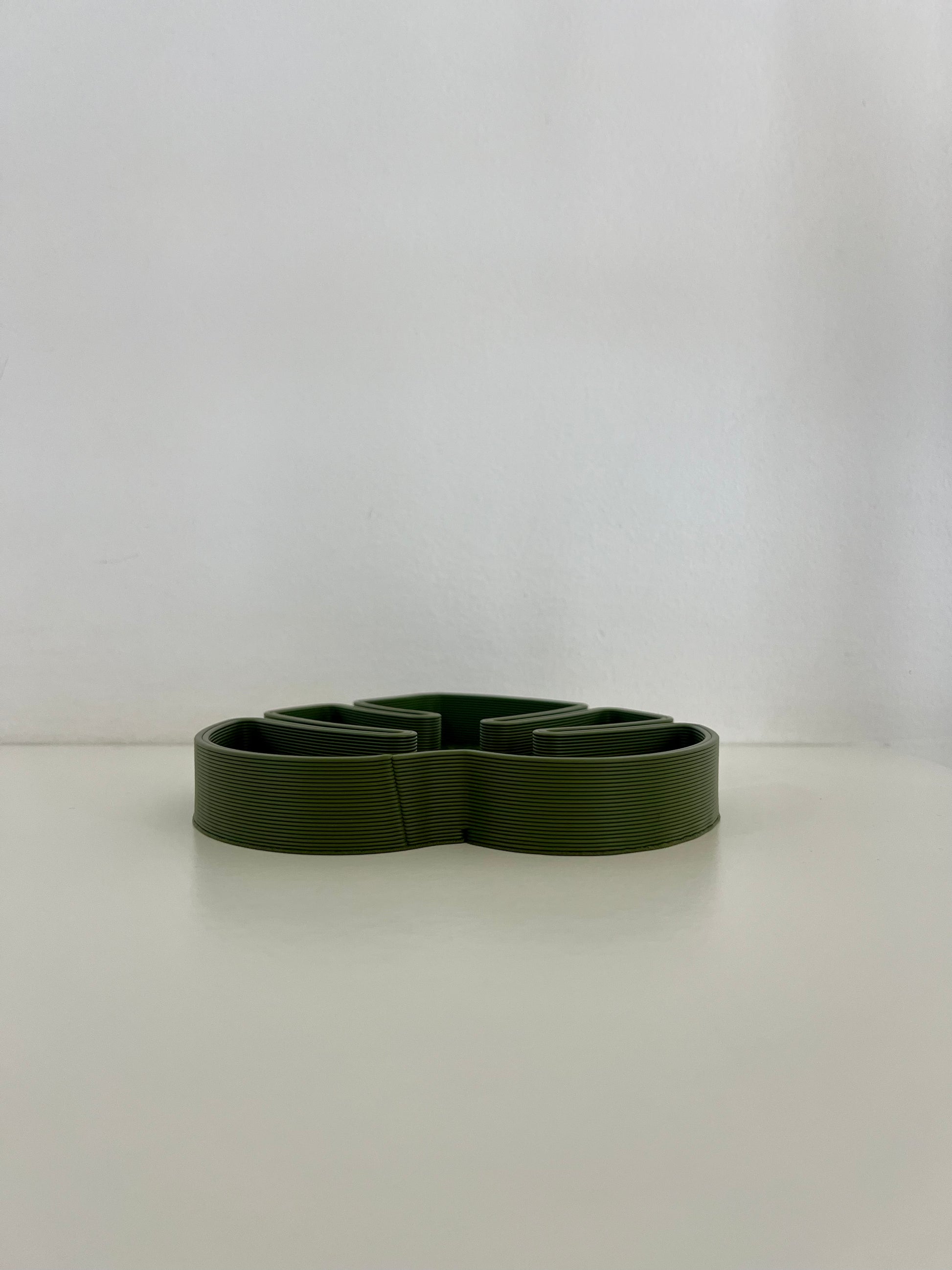 Side view of a green Monstera leaf tray designed for stylish organization of small accessories.
