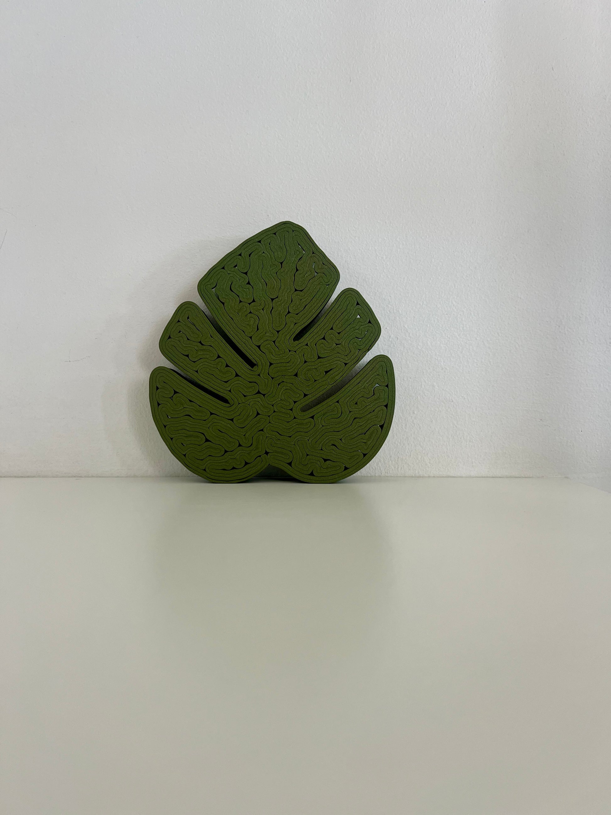 Top view of a green Monstera leaf tray, emphasizing its unique shape and elegant design.