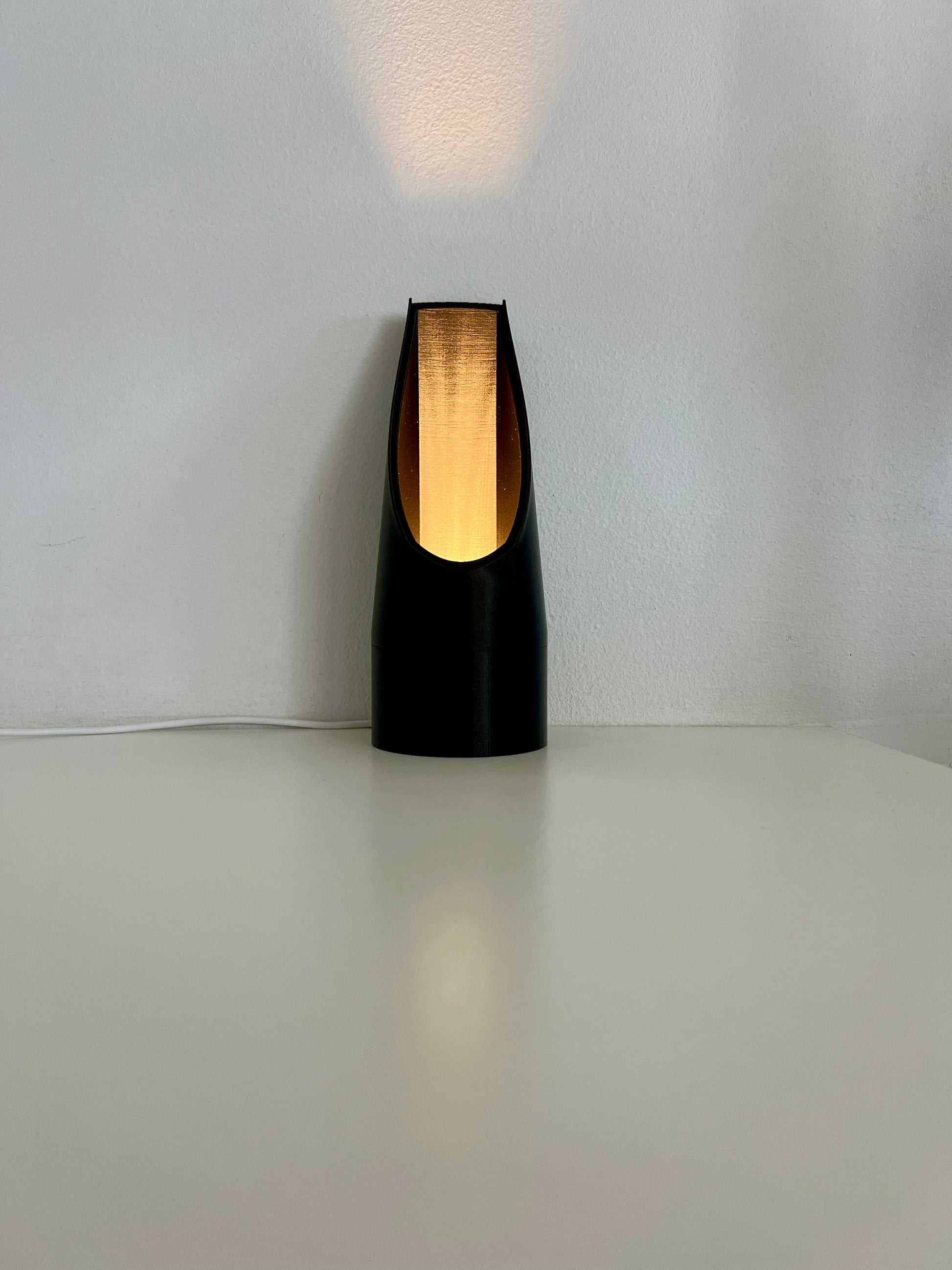 Sleek black mood light showcasing a warm glow, perfect for enhancing any reading space or adding ambiance.