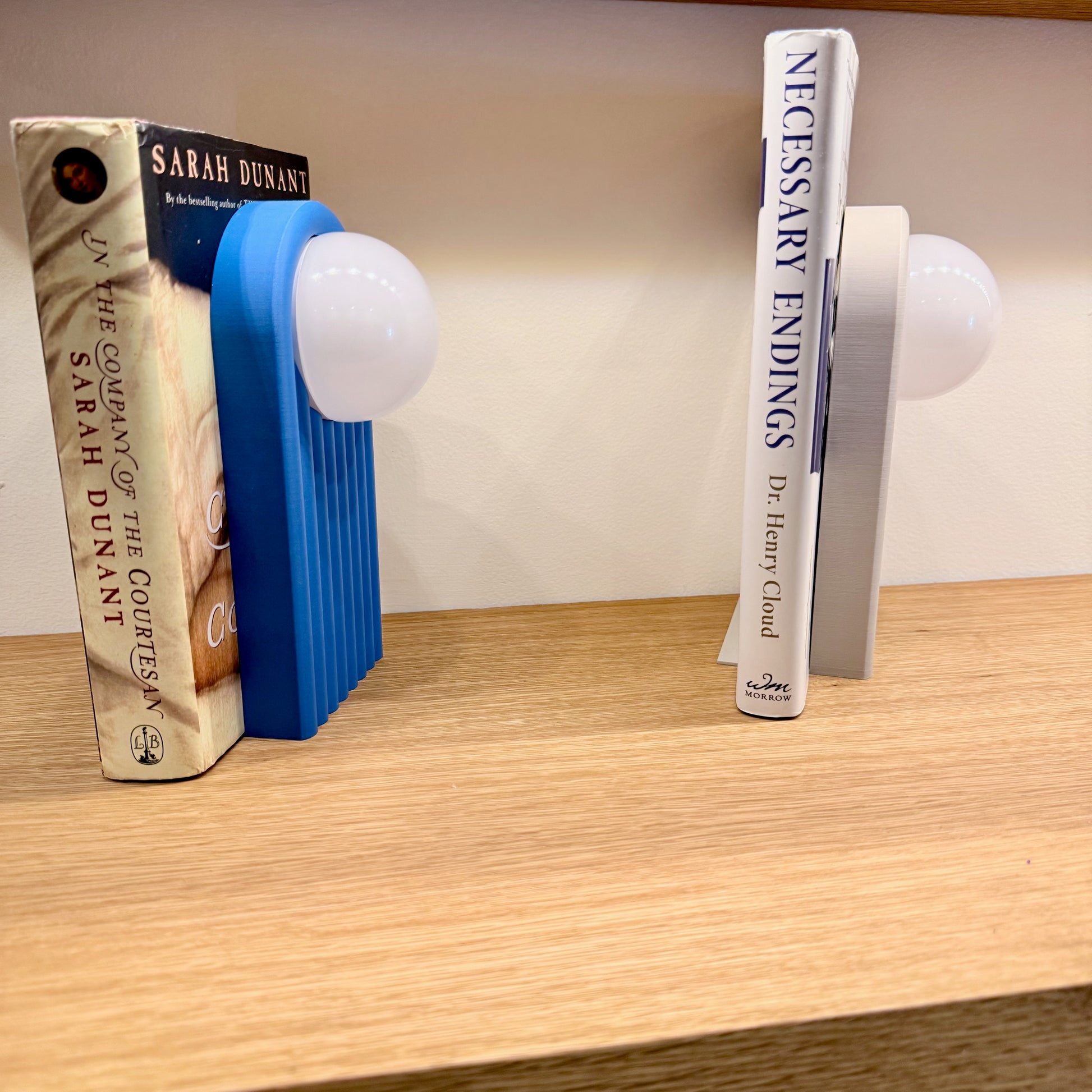 Retro Chic Lighted Bookend for Kids Room or Library showcasing a blue lighted bookend beside books, adding a stylish touch with ambient lighting.