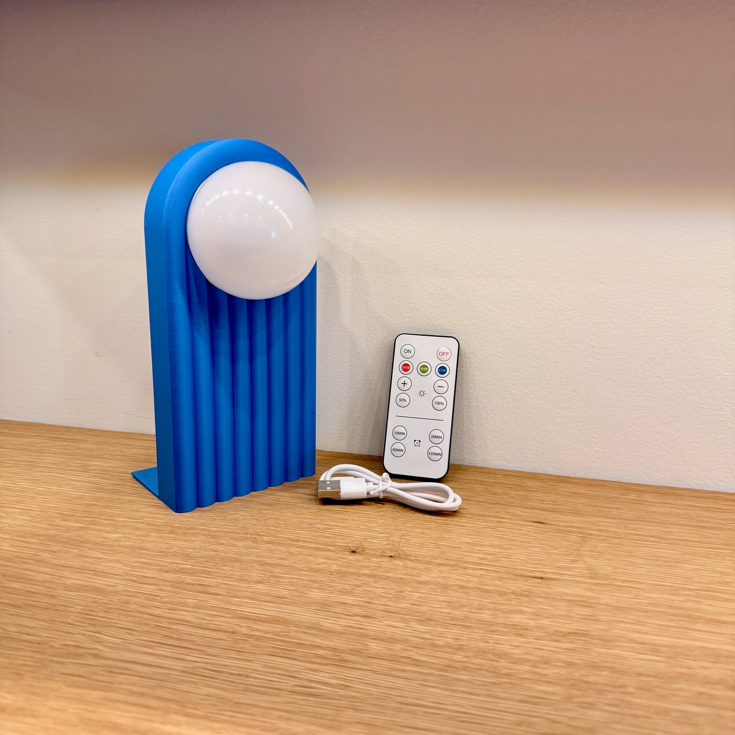 Retro Chic Lighted Bookend for Kids Room or Library featuring a blue bookend and remote control, ideal for adding functional lighting to your bookshelf.