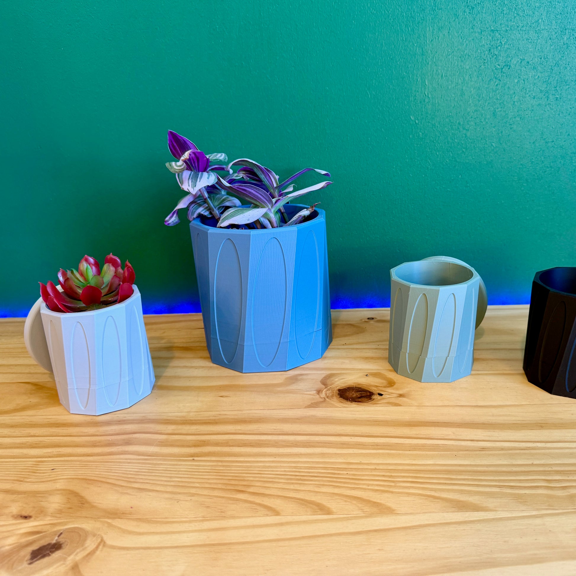 Contemporary decorative planter with a unique faceted shape, designed for wall mounting and offered in a variety of colors.